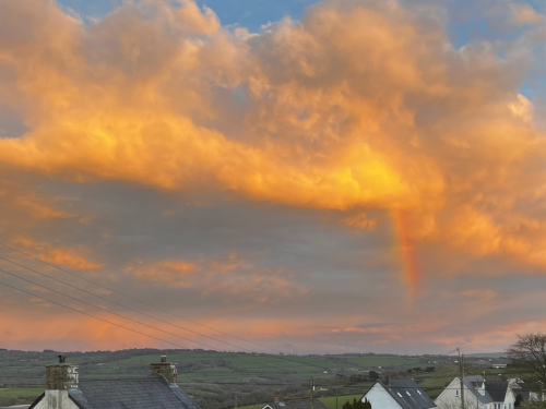 Rainbow over Rhyd Lewis in sunset colors